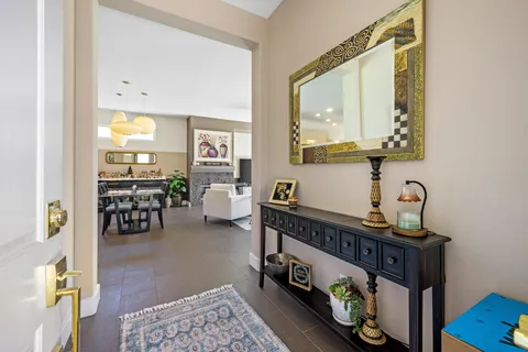a living room with furniture and a mirror
