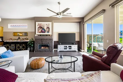 a living room with furniture a fireplace and a flat screen tv