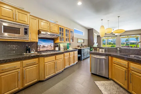 a kitchen with stainless steel appliances granite countertop a stove and a sink