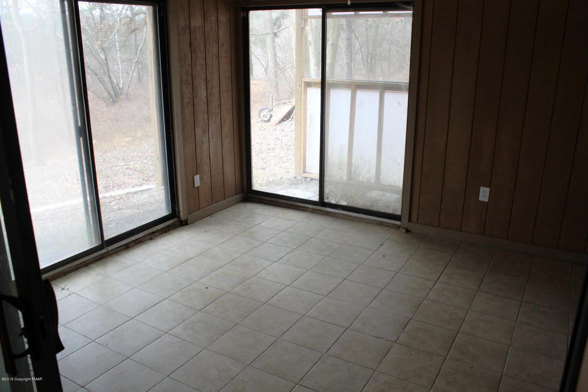 1421 Clover Road Long Pond, PA 18334 - Photo 21 of 26 a view of a livingroom with an empty space and a window