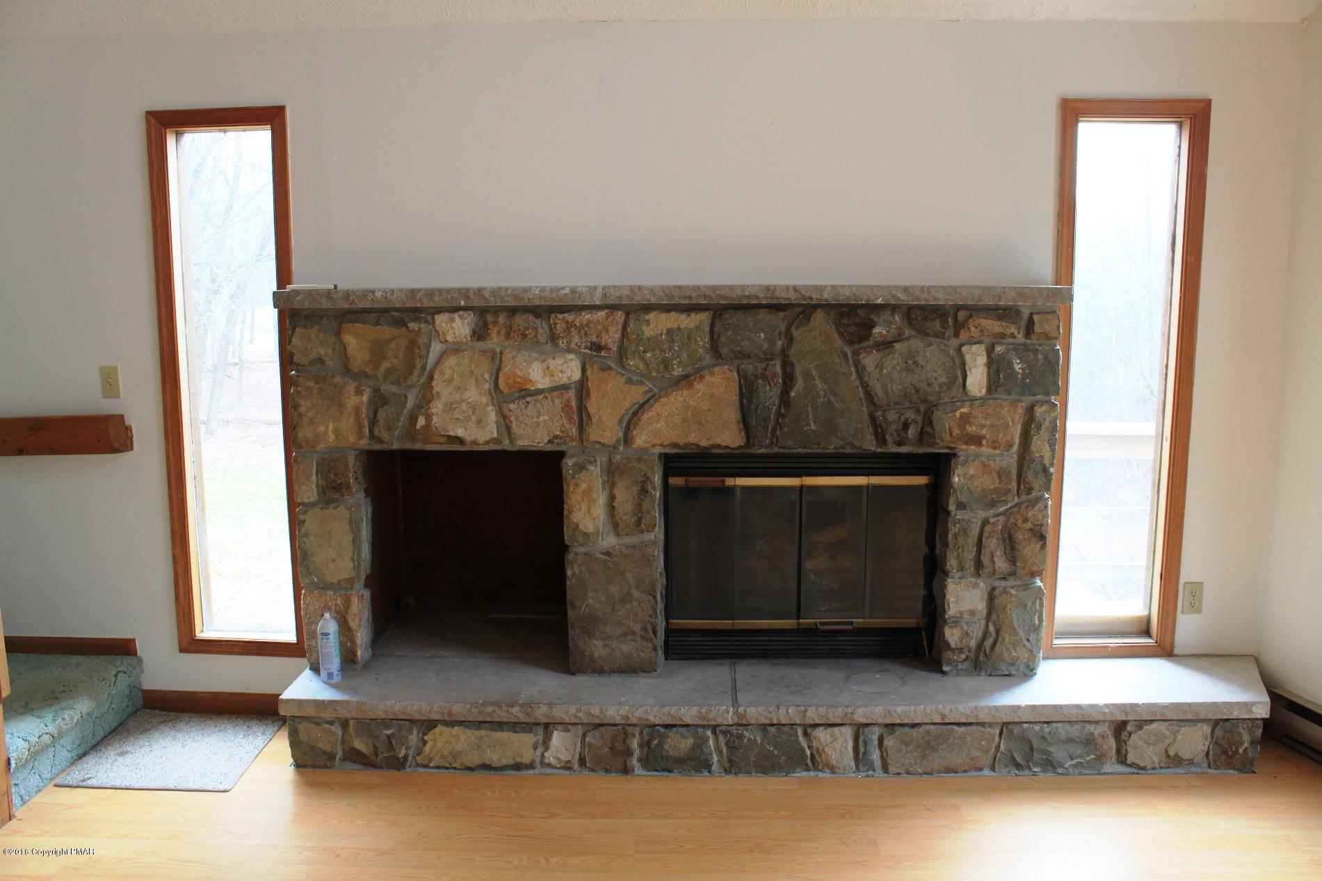 1421 Clover Road Long Pond, PA 18334 - Photo 5 of 26 a living room with fireplace and a wooden floor