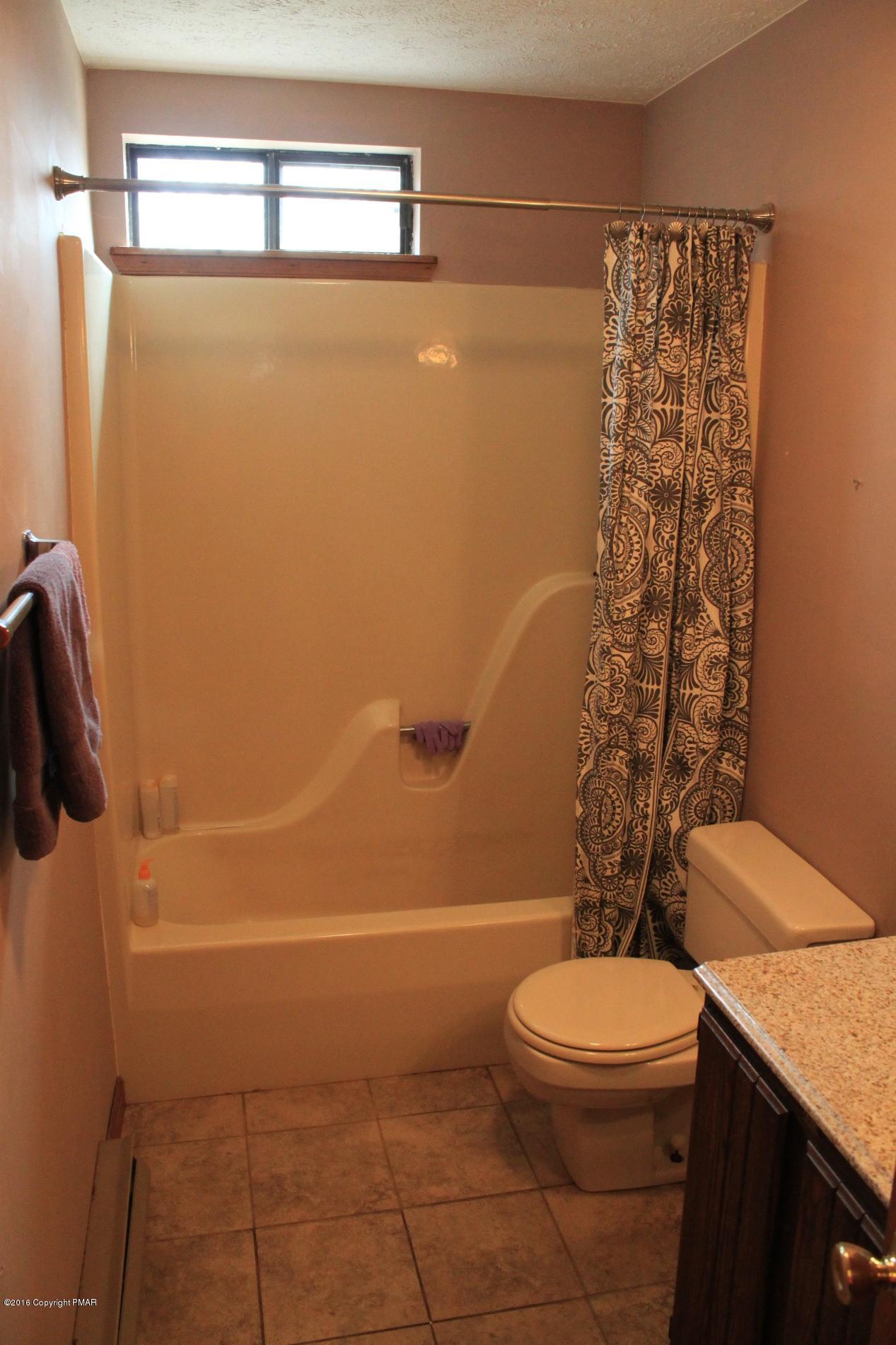 1421 Clover Road Long Pond, PA 18334 - Photo 10 of 26 a bathroom with a toilet and shower
