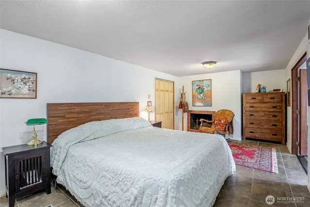 a bedroom with a bed a dresser and book shelf