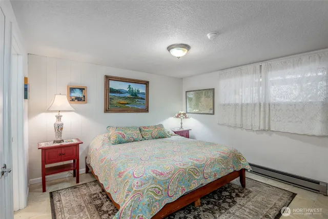 a bedroom with a bed a mirror and a window