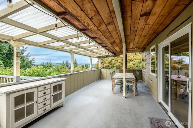 a view of a porch with furniture and next to a yard