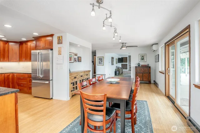 a view of a dining room with furniture a kitchen and chandelier