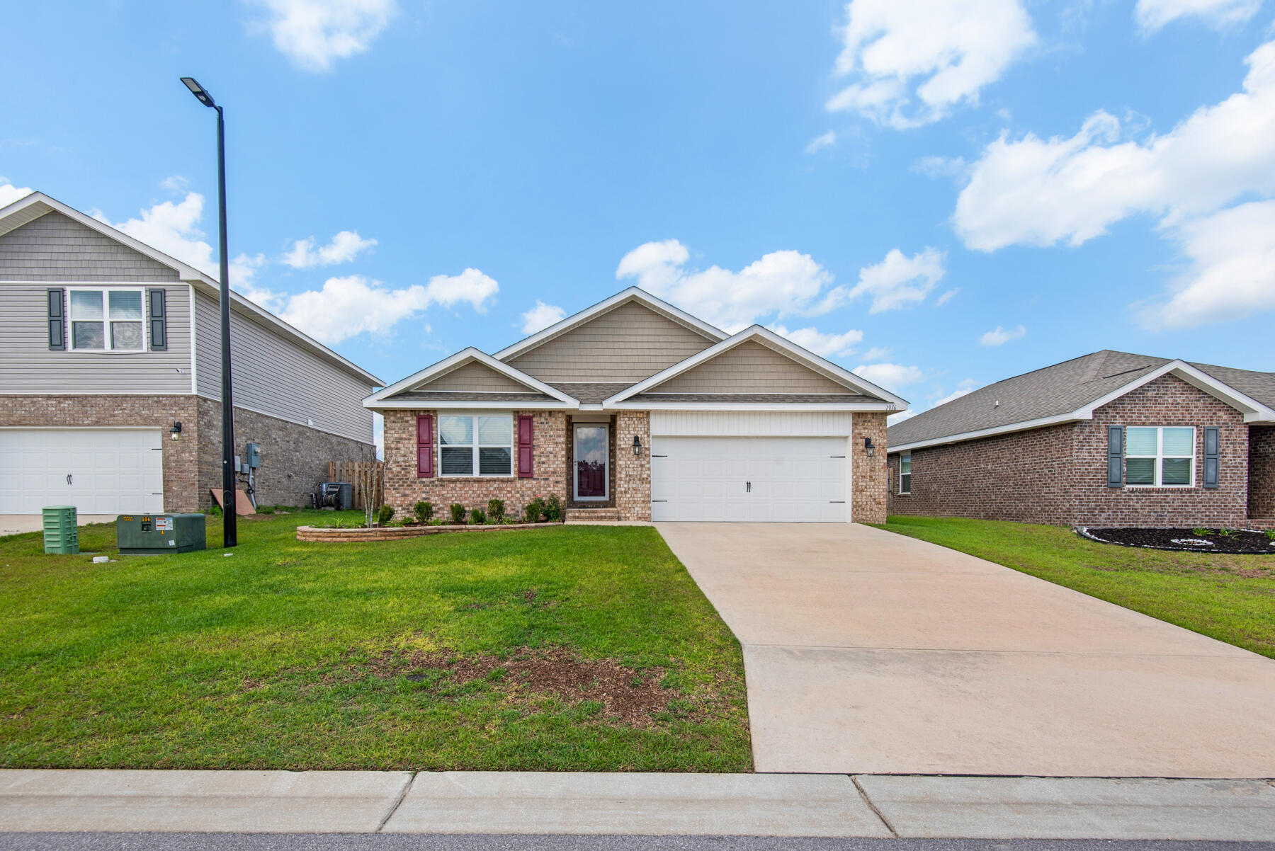 1016 Limpkin Street Crestview, FL 32539 - Photo 1 of 36 a front view of house with yard and garage