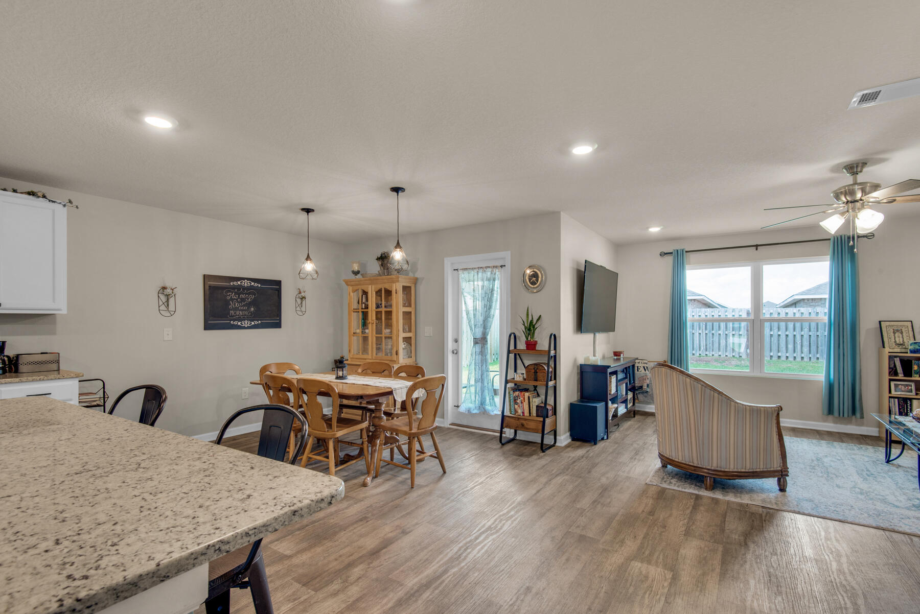 1016 Limpkin Street Crestview, FL 32539 - Photo 12 of 36 a living room with furniture and wooden floor