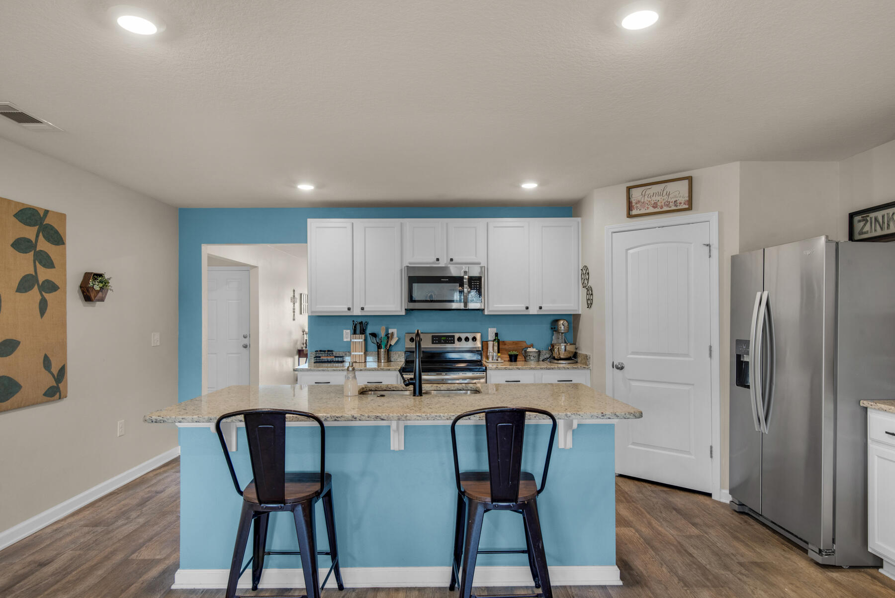 1016 Limpkin Street Crestview, FL 32539 - Photo 13 of 36 a kitchen with stainless steel appliances a refrigerator and a stove top oven