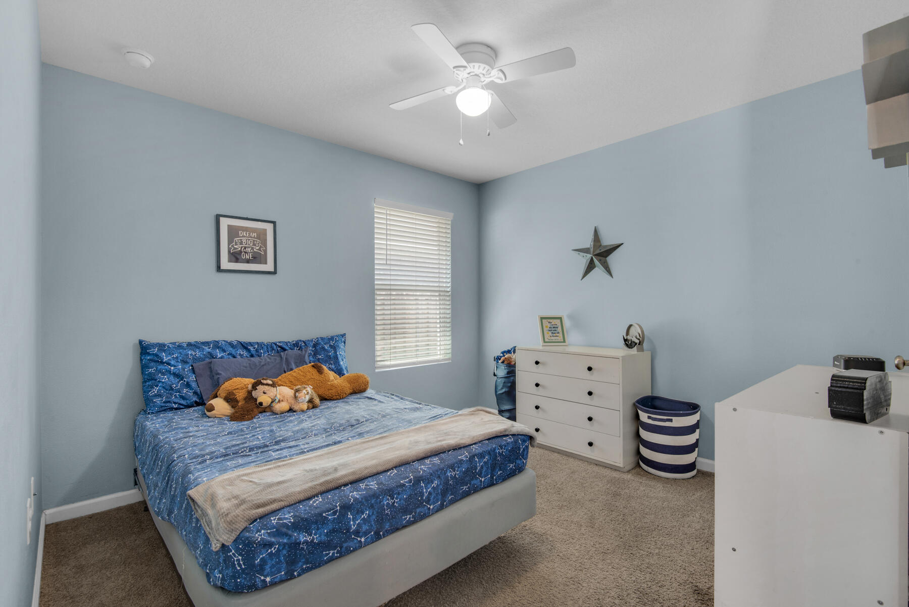 1016 Limpkin Street Crestview, FL 32539 - Photo 20 of 36 a bedroom with a bed and a chandelier