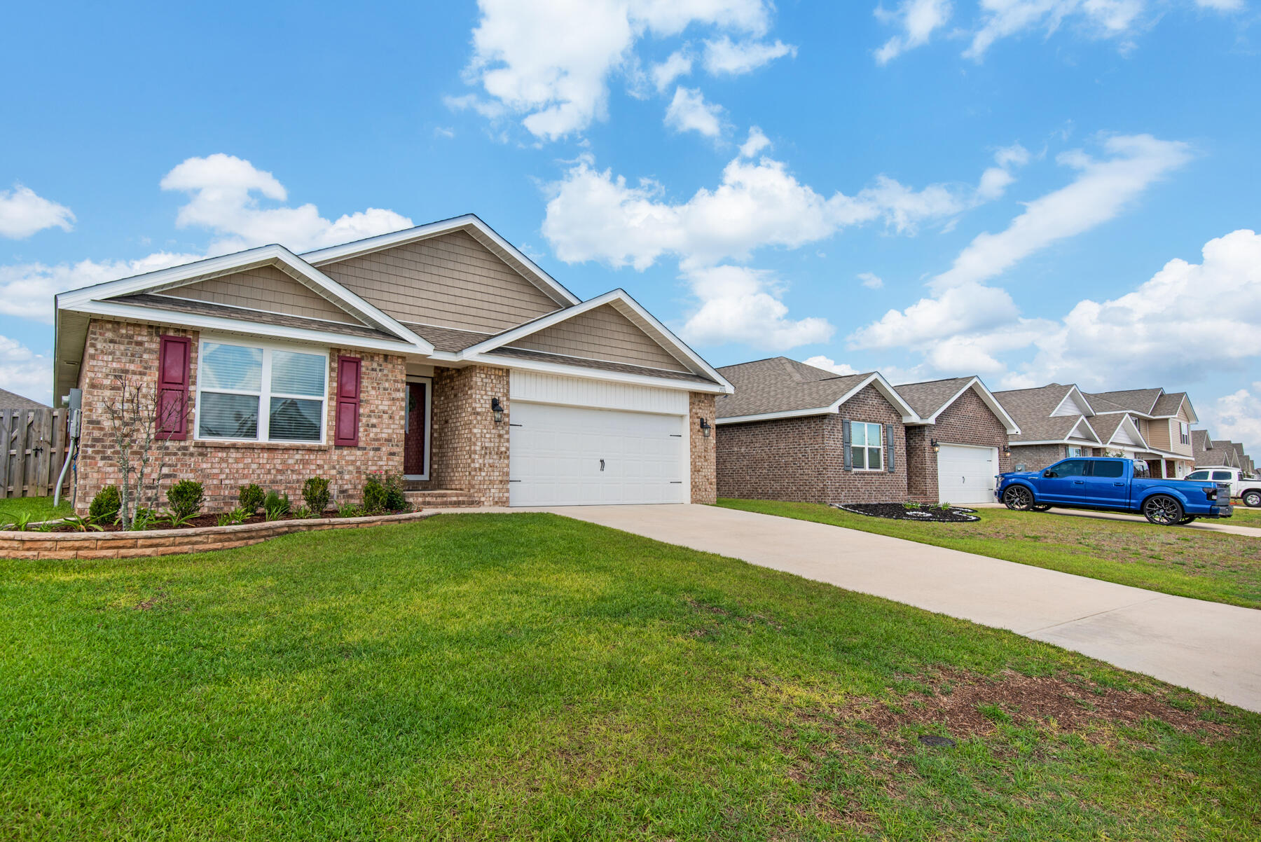 1016 Limpkin Street Crestview, FL 32539 - Photo 2 of 36 a front view of a house with a garden and yard