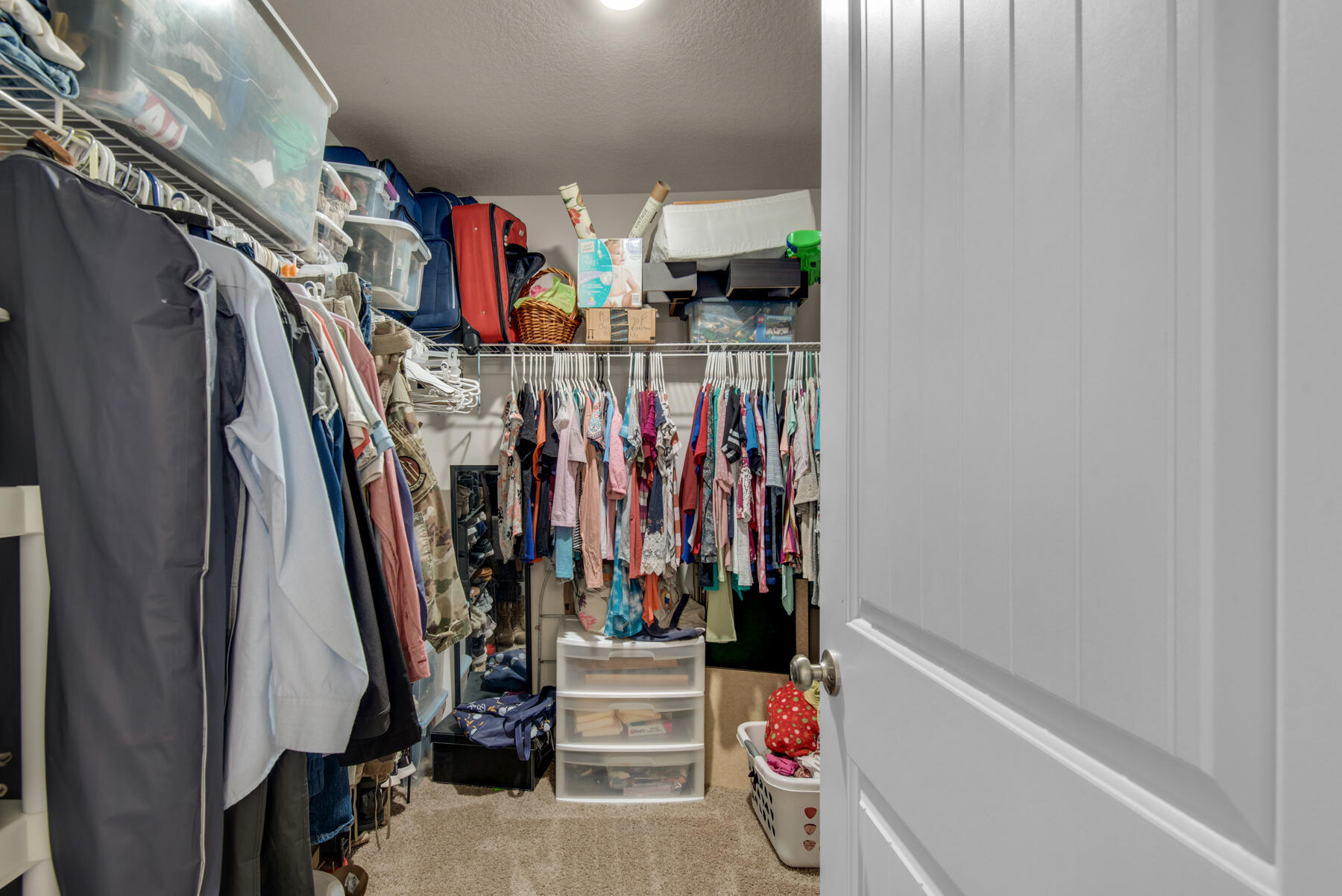 1016 Limpkin Street Crestview, FL 32539 - Photo 23 of 36 a view of walk in closet with clothes