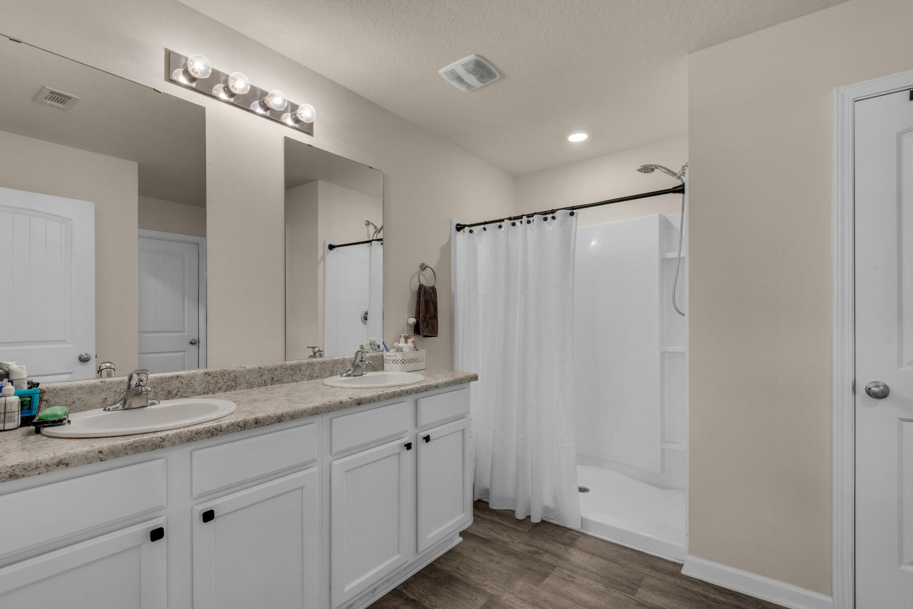 1016 Limpkin Street Crestview, FL 32539 - Photo 25 of 36 a bathroom with a double vanity sink and a mirror