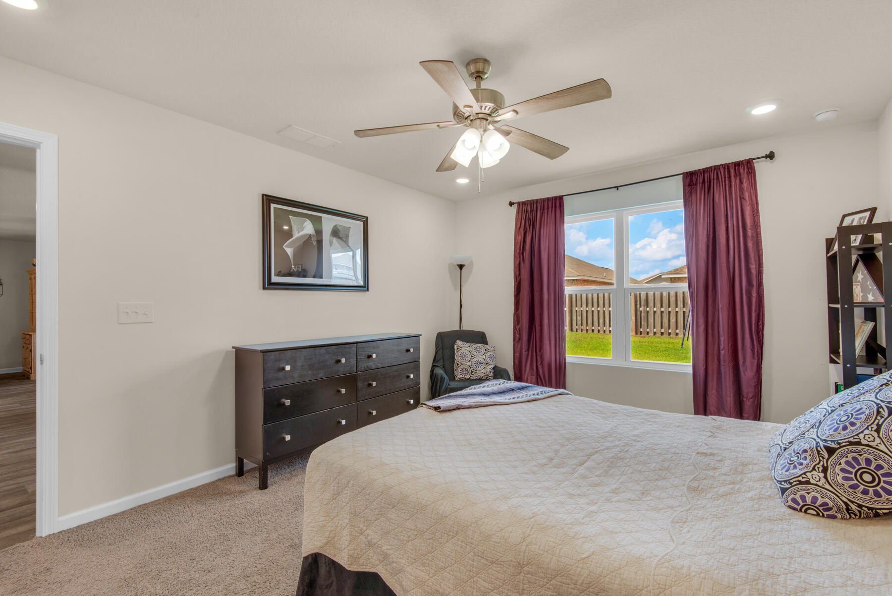 1016 Limpkin Street Crestview, FL 32539 - Photo 27 of 36 a bedroom with a bed and a chandelier