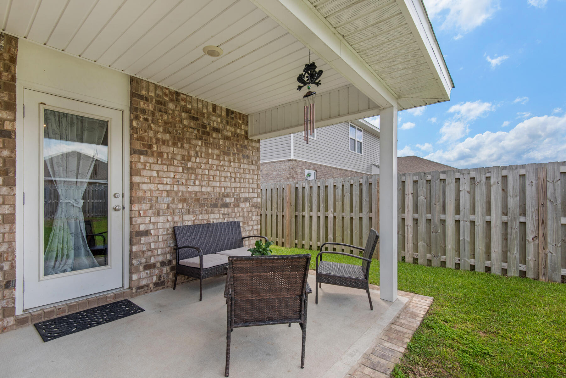 1016 Limpkin Street Crestview, FL 32539 - Photo 31 of 36 a view of a porch with furniture and a yard