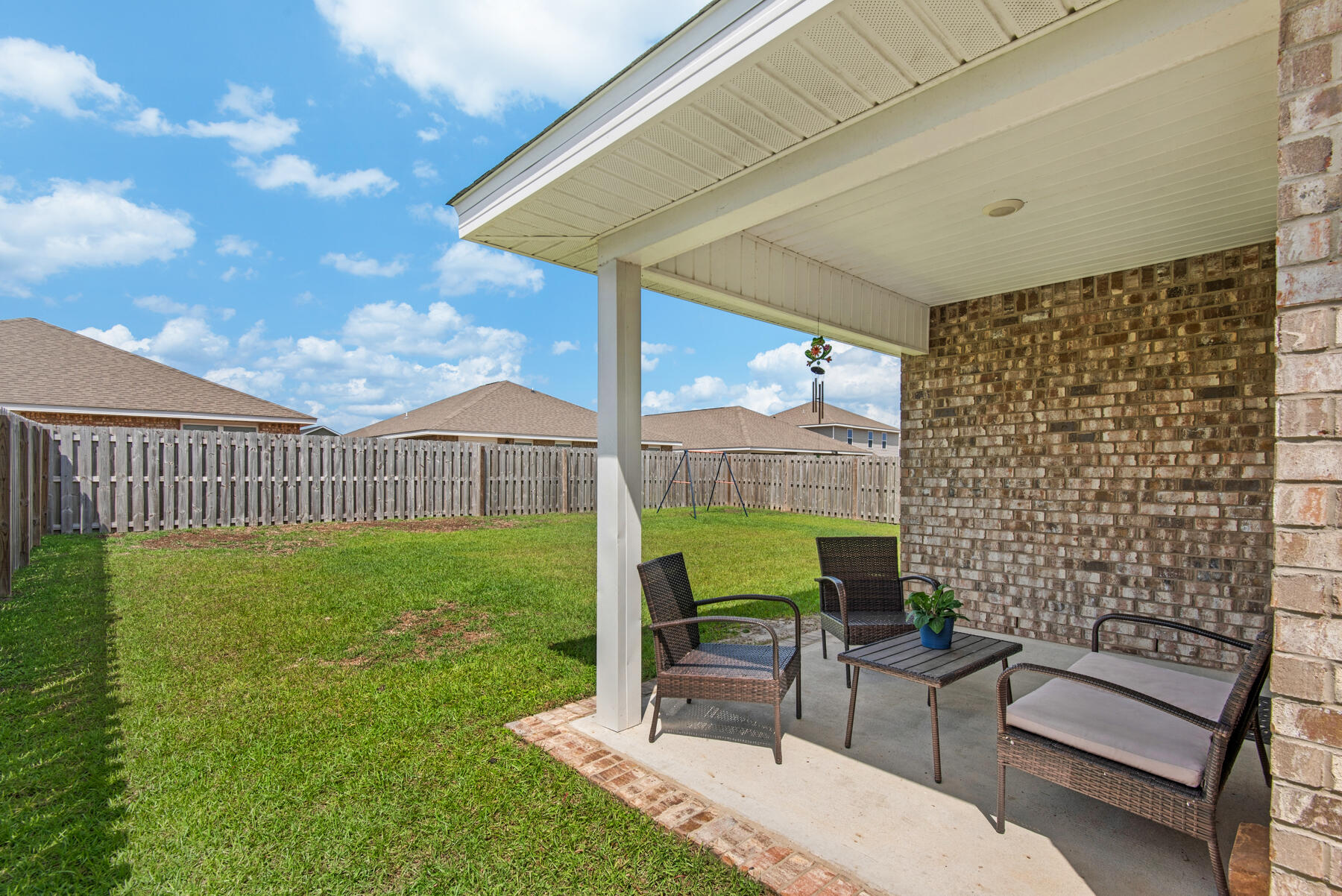 1016 Limpkin Street Crestview, FL 32539 - Photo 32 of 36 a view of a patio with table and chairs with wooden fence