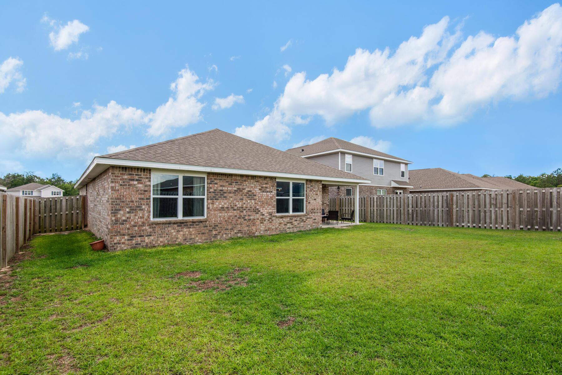 1016 Limpkin Street Crestview, FL 32539 - Photo 33 of 36 a view of a big house with a big yard and large trees