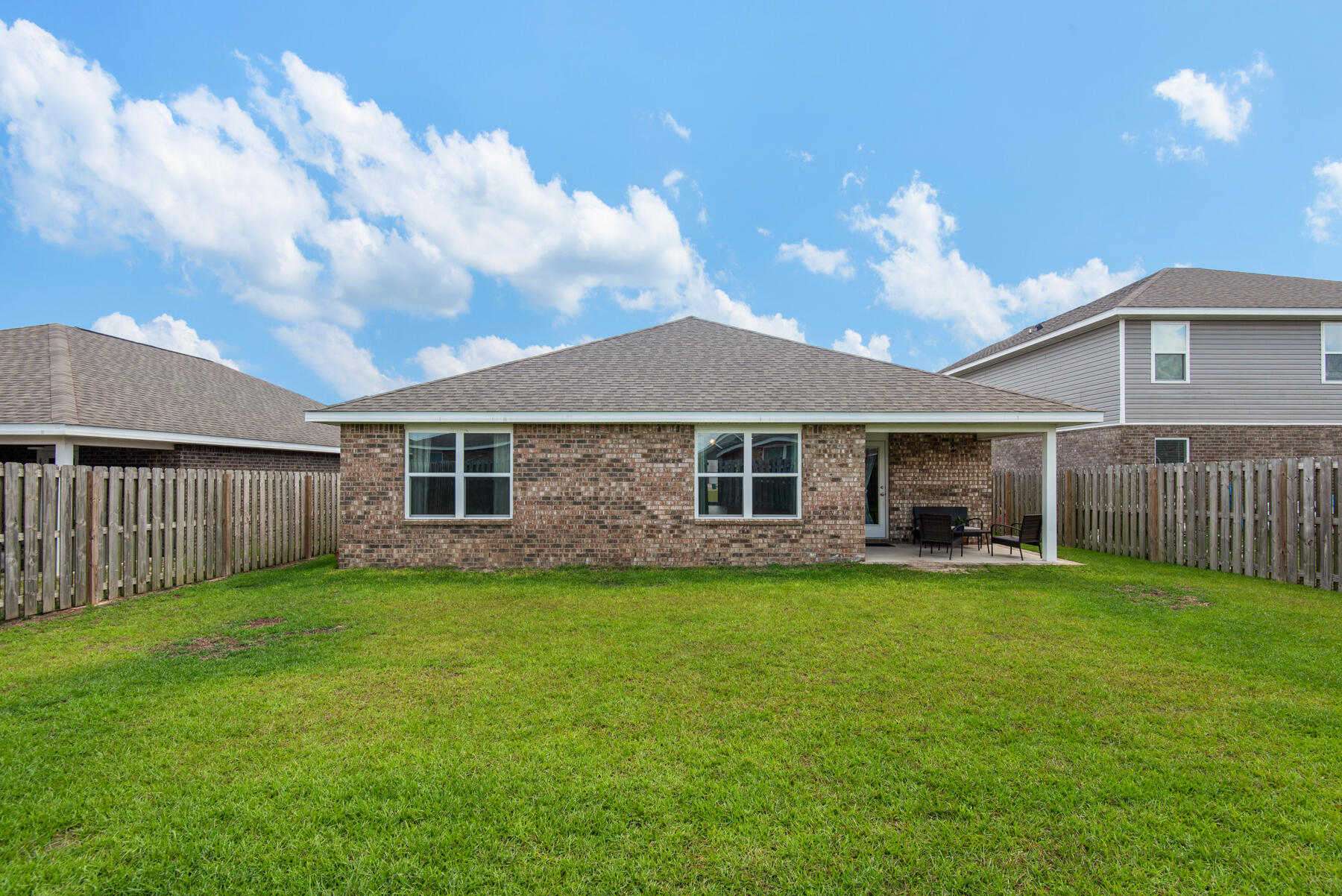 1016 Limpkin Street Crestview, FL 32539 - Photo 34 of 36 a view of a yard in front of a house with a yard