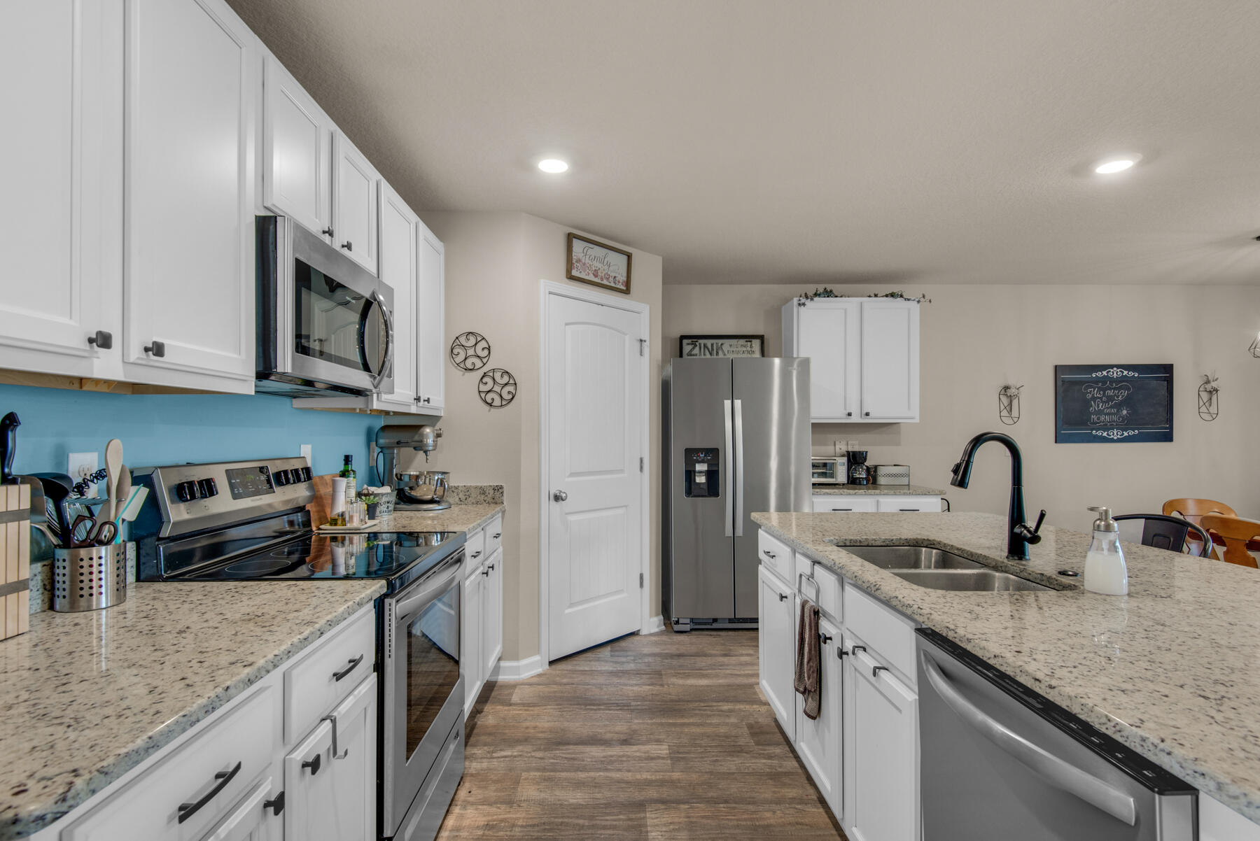 1016 Limpkin Street Crestview, FL 32539 - Photo 5 of 36 a kitchen with stainless steel appliances granite countertop a sink stove and refrigerator