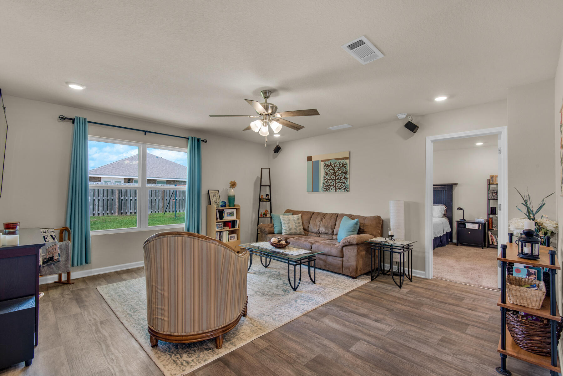1016 Limpkin Street Crestview, FL 32539 - Photo 6 of 36 a living room with furniture and a floor to ceiling window
