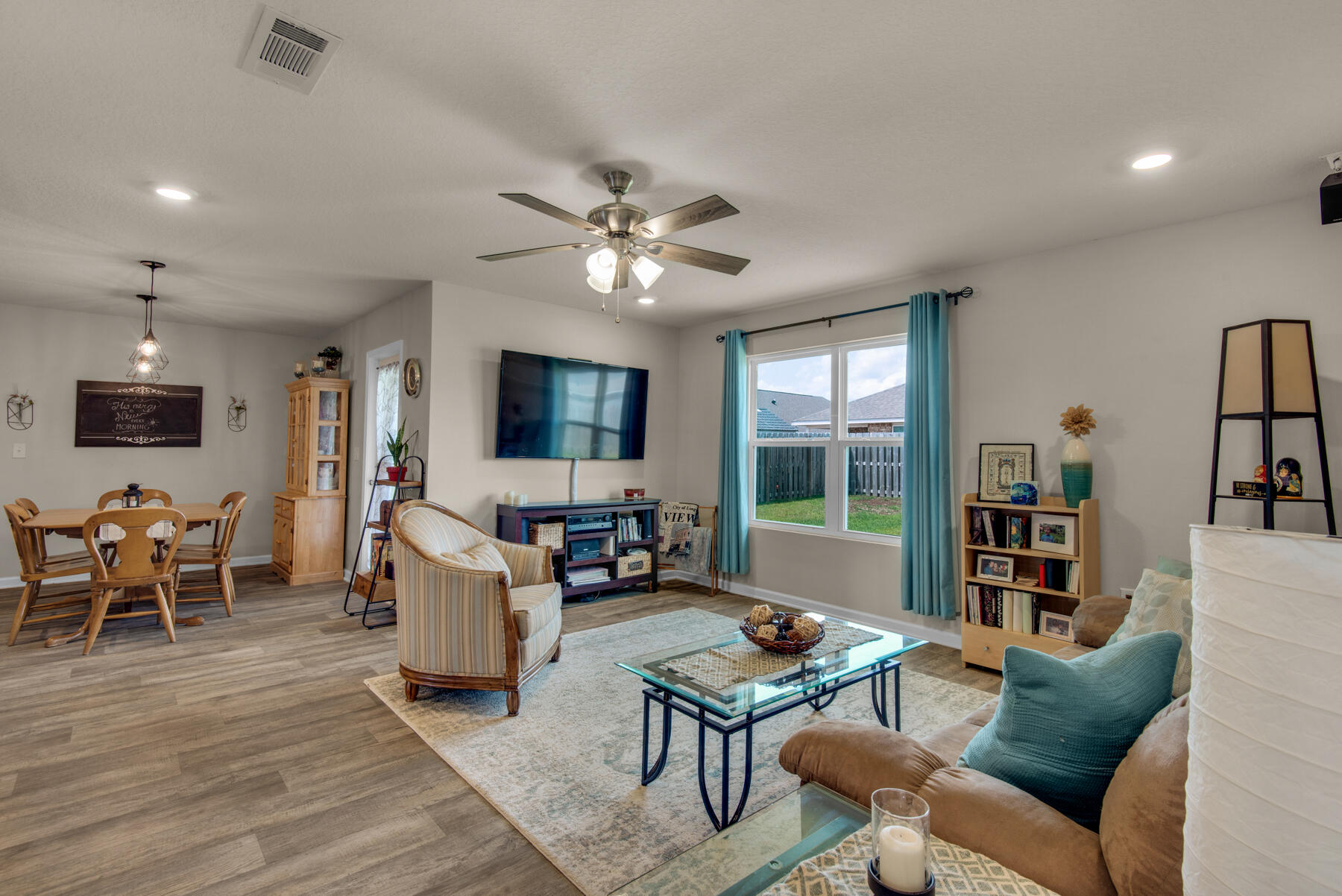 1016 Limpkin Street Crestview, FL 32539 - Photo 7 of 36 a living room with furniture a flat screen tv and a large window