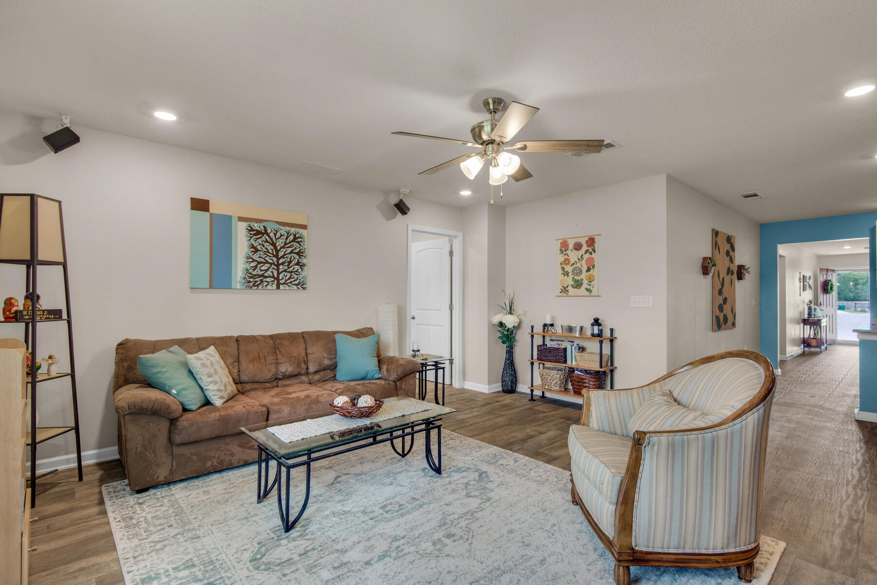 1016 Limpkin Street Crestview, FL 32539 - Photo 9 of 36 a living room with furniture a rug and a chandelier