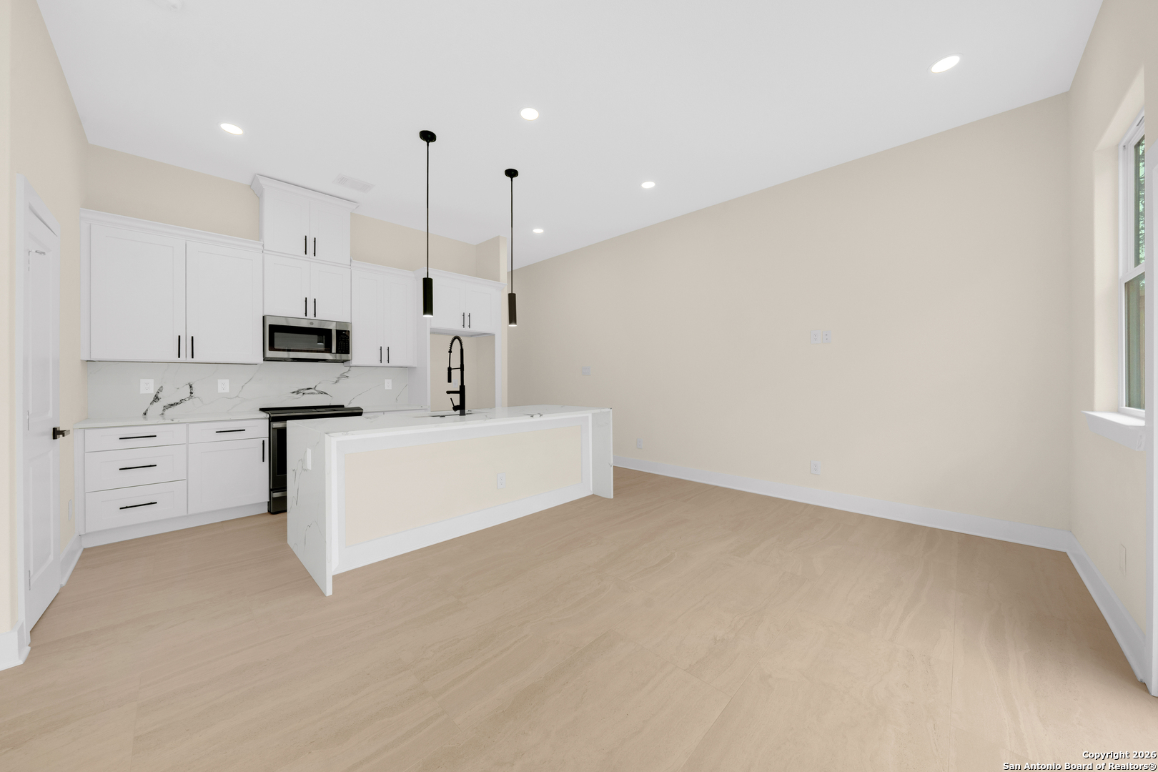 11710 Vance Jackson Road, Unit 702 San Antonio, TX 78230 - Photo 14 of 25 a large white kitchen with white cabinets
