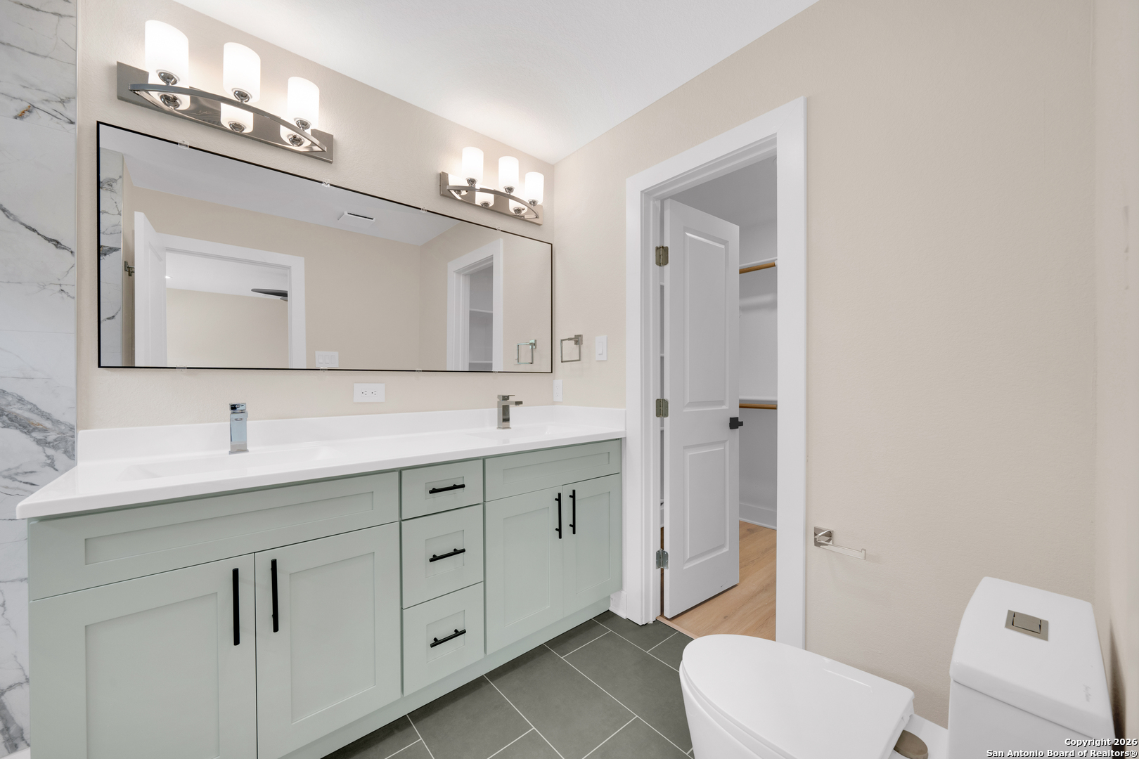 11710 Vance Jackson Road, Unit 702 San Antonio, TX 78230 - Photo 19 of 25 a bathroom with a toilet a sink a mirror and vanity