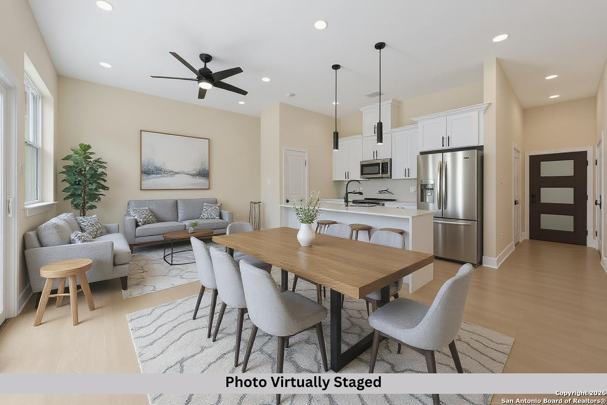 11710 Vance Jackson Road, Unit 702 San Antonio, TX 78230 - Photo 2 of 25 a kitchen with stainless steel appliances kitchen island granite countertop a dining table chairs and a refrigerator