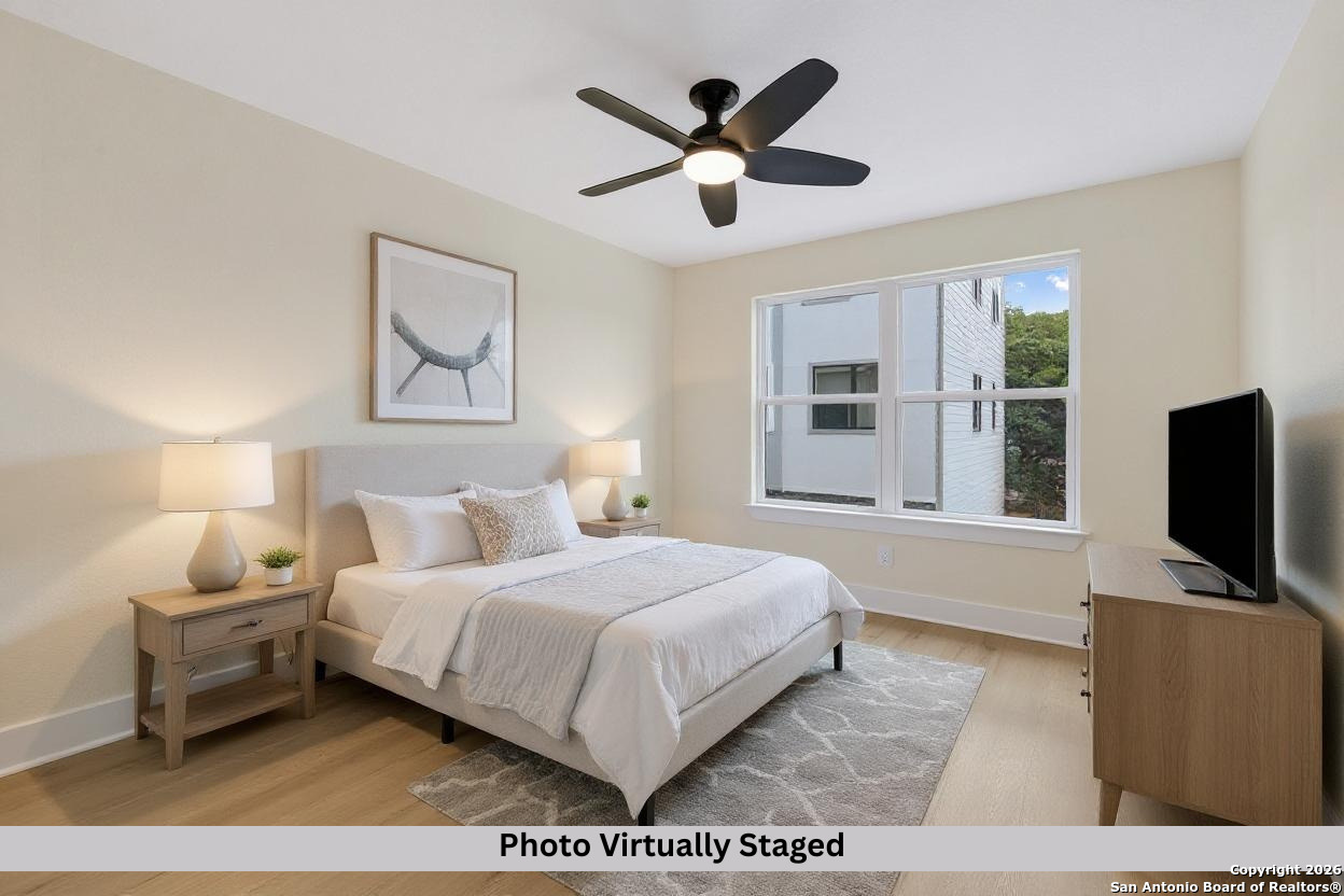 11710 Vance Jackson Road, Unit 702 San Antonio, TX 78230 - Photo 3 of 25 a bedroom with a bed window and a flat screen tv