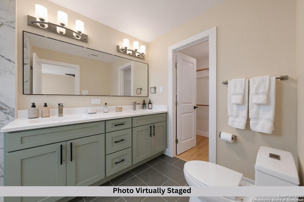 11710 Vance Jackson Road, Unit 702 San Antonio, TX 78230 - Photo 5 of 25 a spacious bathroom with a granite countertop sink mirror and a bathtub