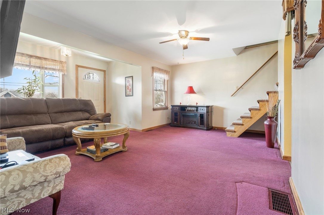 1850 South Sawburg Road Alliance, OH 44601 - Photo 10 of 39 Carpeted living room with ceiling fan/light, arched doorways and bay window