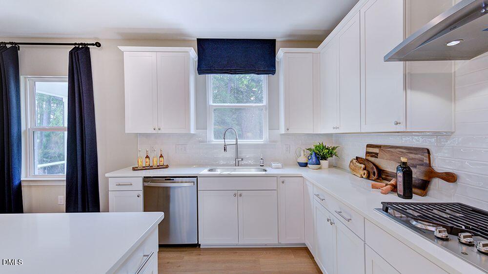 222 Tidal Pool Way Cary, NC 27519 - Photo 12 of 25 a kitchen with a sink stove and cabinets