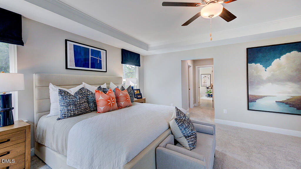 222 Tidal Pool Way Cary, NC 27519 - Photo 17 of 25 a bedroom with a large bed and a chandelier