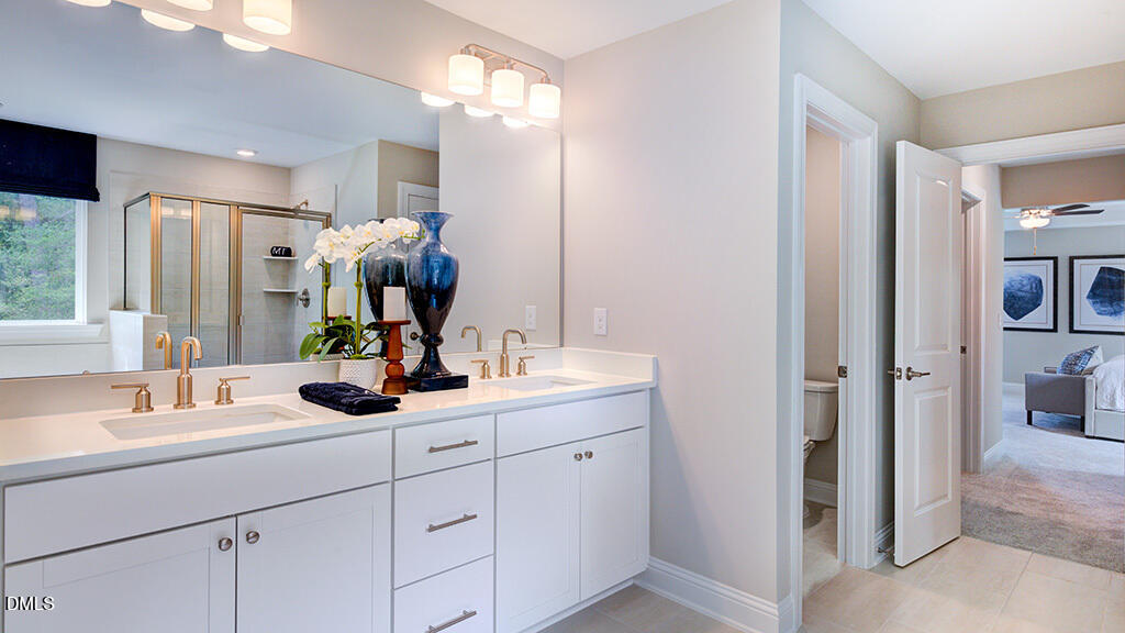 222 Tidal Pool Way Cary, NC 27519 - Photo 18 of 25 a bathroom with a sink double vanity and a mirror