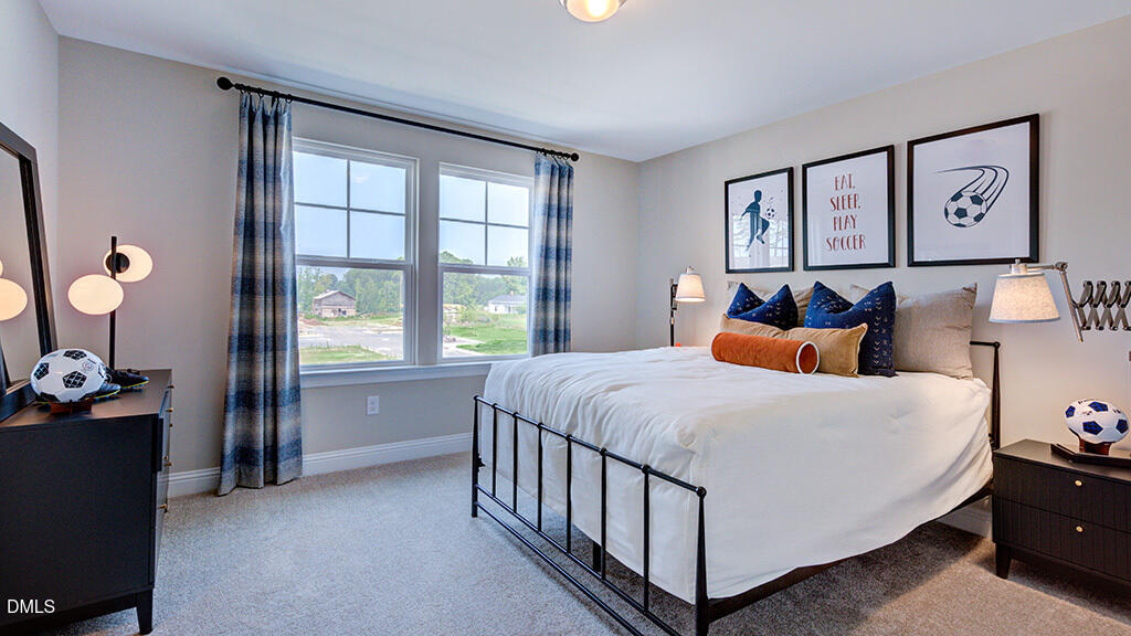 222 Tidal Pool Way Cary, NC 27519 - Photo 19 of 25 a bed sitting in a bedroom next to a window