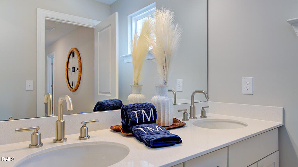 222 Tidal Pool Way Cary, NC 27519 - Photo 23 of 25 a bathroom with a granite countertop double vanity sink and a mirror