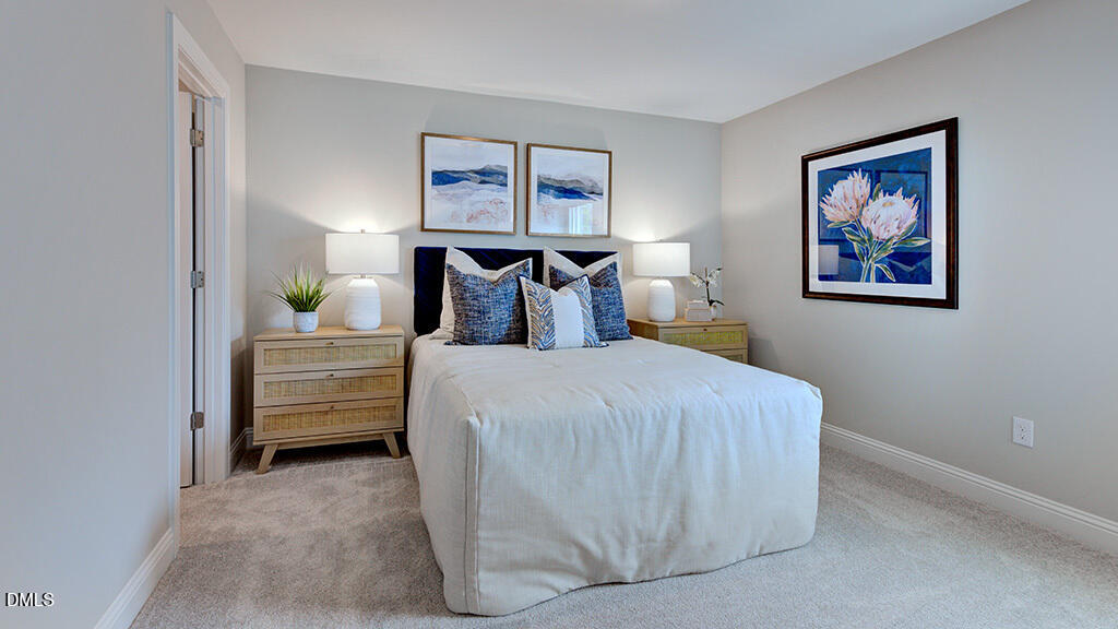 222 Tidal Pool Way Cary, NC 27519 - Photo 24 of 25 a bedroom with a bed and a painting on the wall