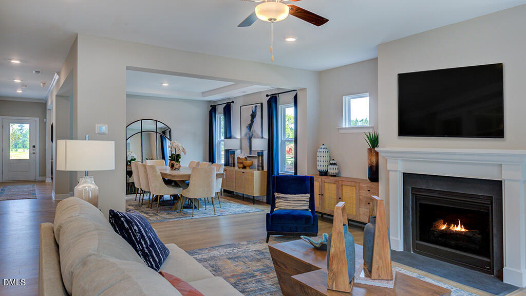 222 Tidal Pool Way Cary, NC 27519 - Photo 4 of 25 a living room with furniture a fireplace and a flat screen tv