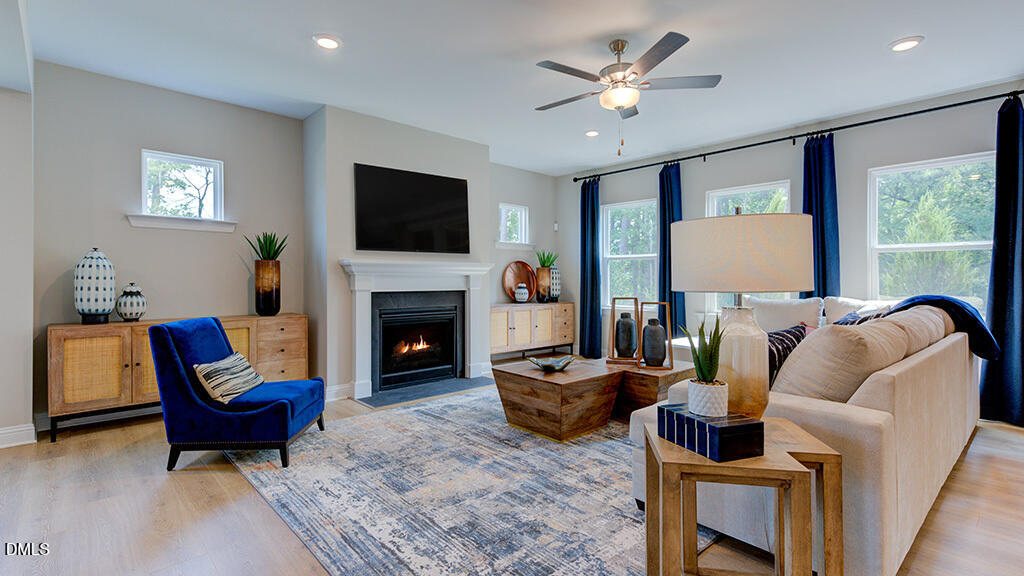 222 Tidal Pool Way Cary, NC 27519 - Photo 5 of 25 a living room with furniture a fireplace and a flat screen tv