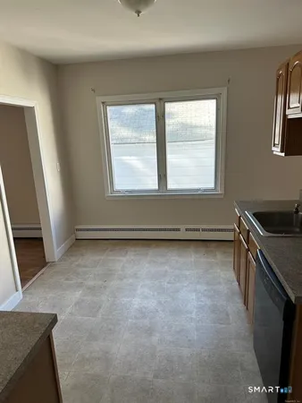 a view of an empty room and wooden floor