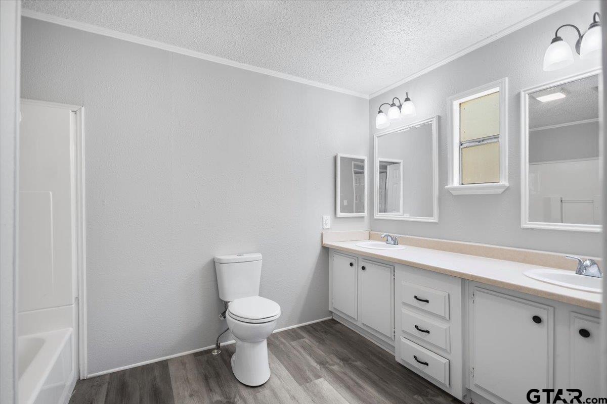 18607-c R 498 C R 498 Lindale, TX 75771 - Photo 25 of 41 a bathroom with a toilet sink and mirror