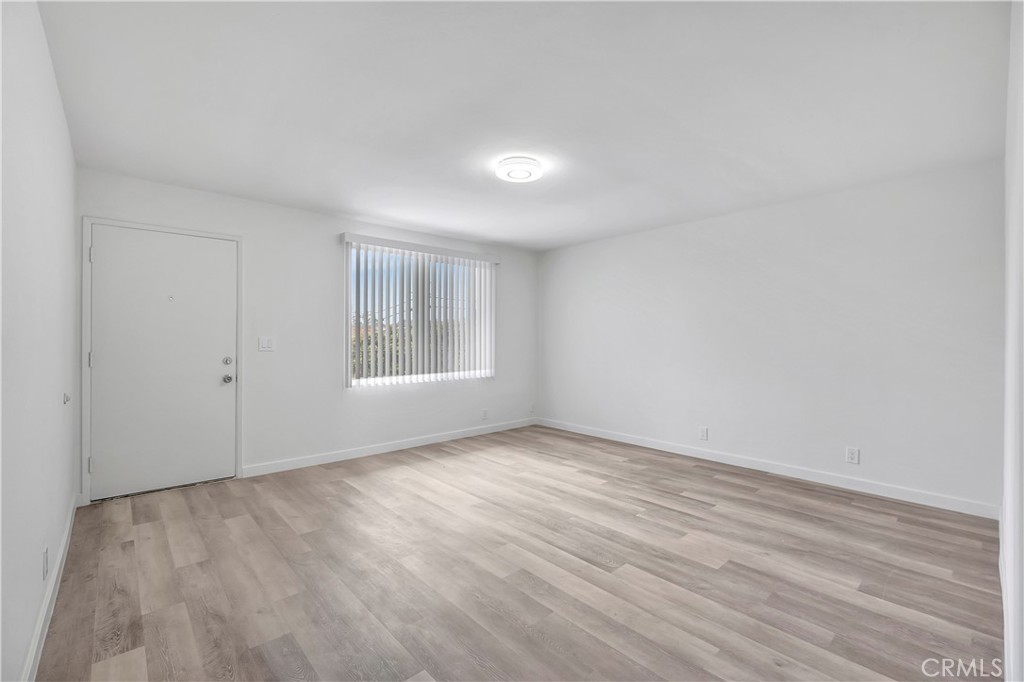 1813 West Ball Road Anaheim, CA 92804 - Photo 11 of 36 a view of an empty room with wooden floor and a window