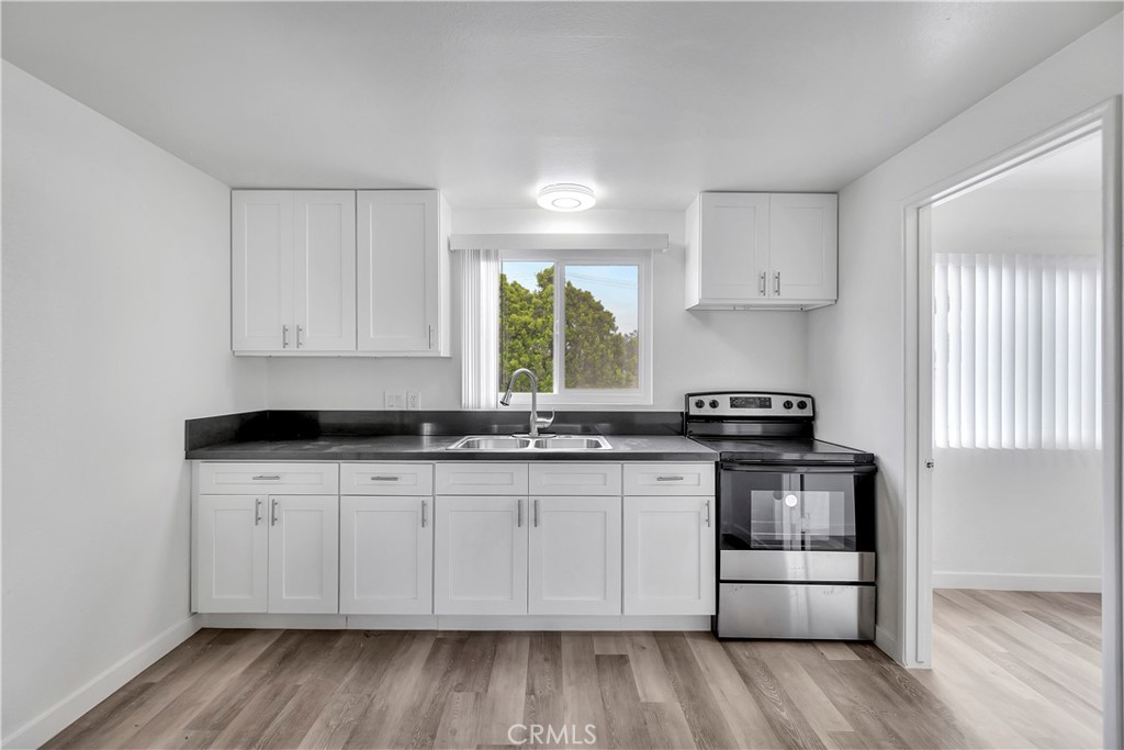 1813 West Ball Road Anaheim, CA 92804 - Photo 16 of 36 a kitchen with stainless steel appliances a sink stove and cabinets