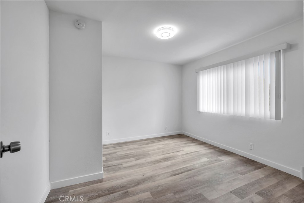 1813 West Ball Road Anaheim, CA 92804 - Photo 18 of 36 an empty room with wooden floor and windows