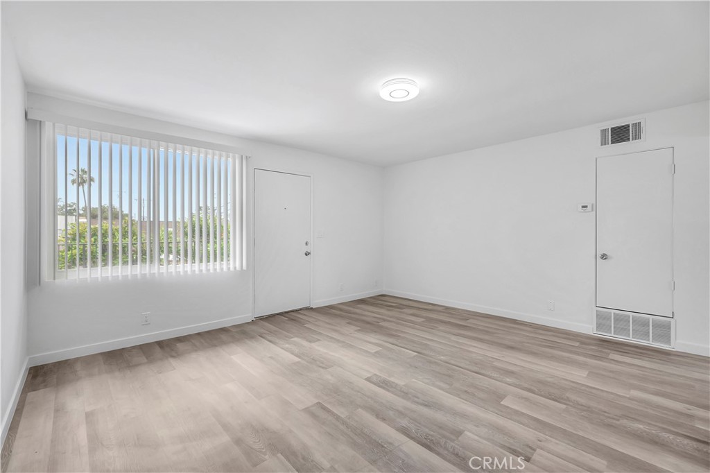 1813 West Ball Road Anaheim, CA 92804 - Photo 20 of 36 a view of an empty room with wooden floor and a window