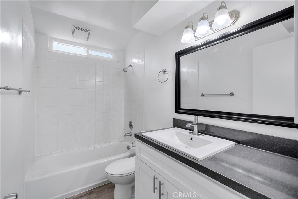 1813 West Ball Road Anaheim, CA 92804 - Photo 24 of 36 a bathroom with a sink a toilet a mirror and shower