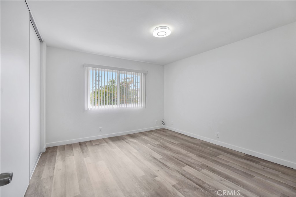 1813 West Ball Road Anaheim, CA 92804 - Photo 27 of 36 an empty room with wooden floor and windows