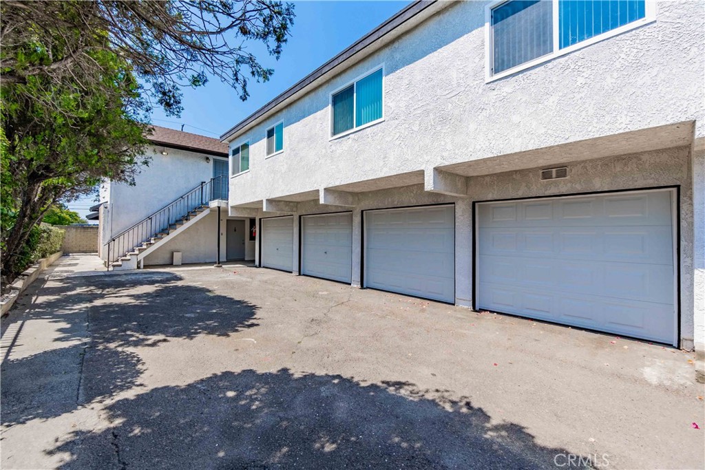 1813 West Ball Road Anaheim, CA 92804 - Photo 32 of 36 a front view of a house with a yard and garage