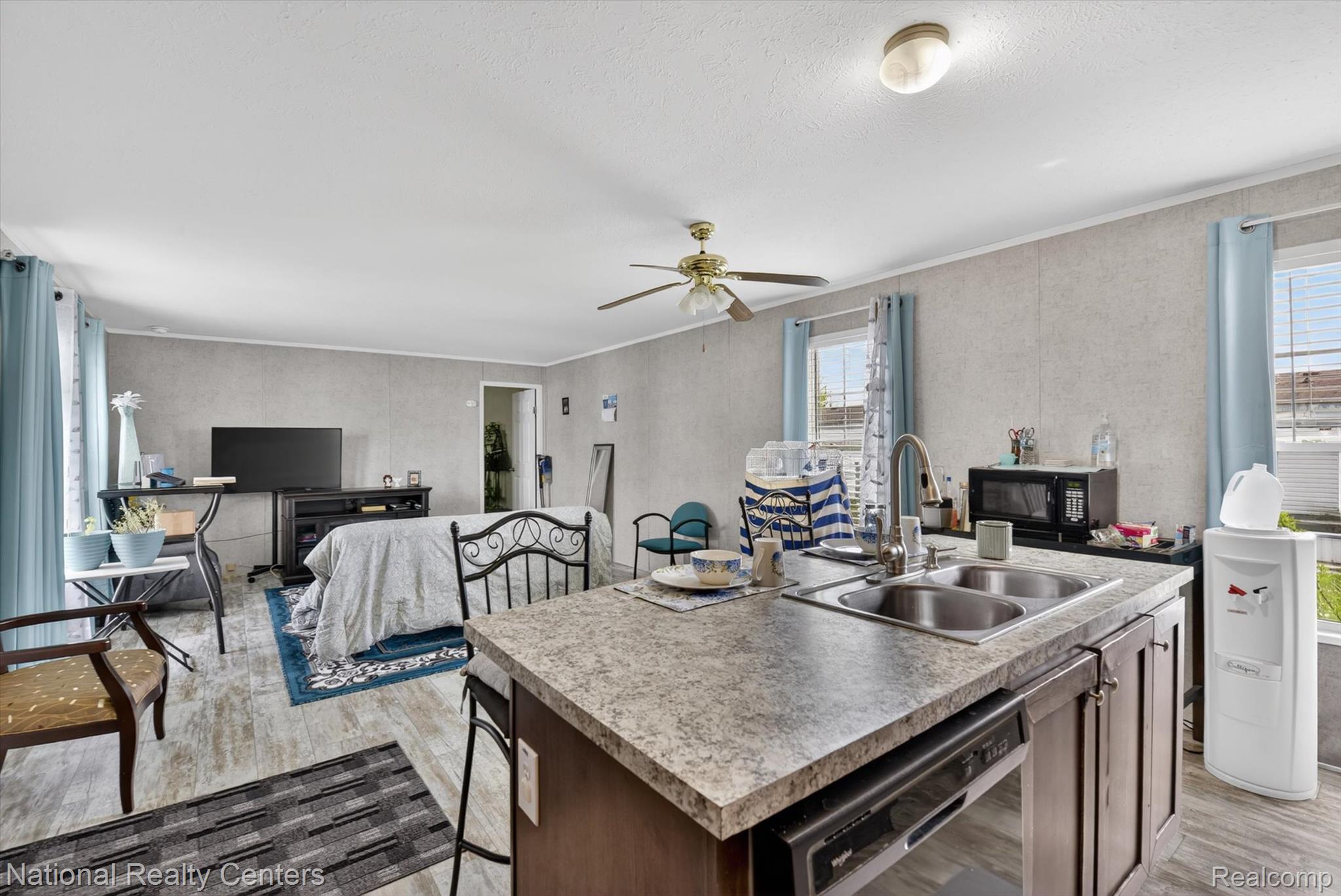 2735 South Wagner Road, Unit 103 Ann Arbor, MI 48103 - Photo 20 of 20 Kitchen featuring an island with sink, light wood-style flooring, open floor plan, and plenty of natural light